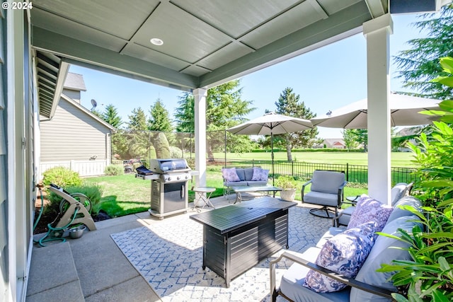 view of patio / terrace with an outdoor living space with a fire pit and grilling area