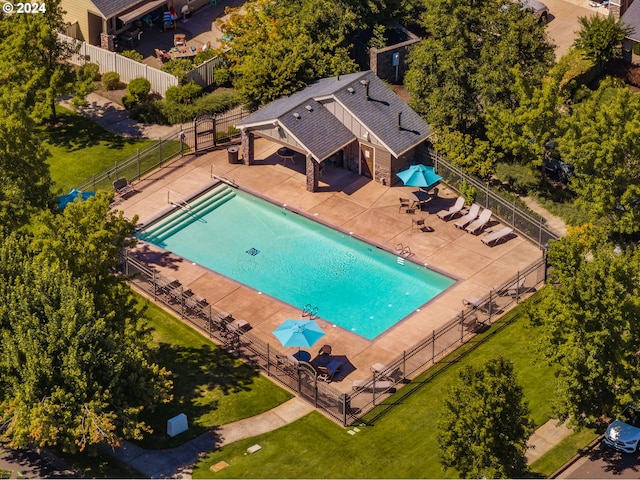 view of swimming pool featuring a yard and a patio area