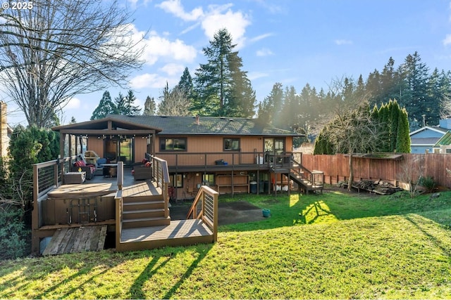 rear view of house with a gazebo, a lawn, a hot tub, and a deck