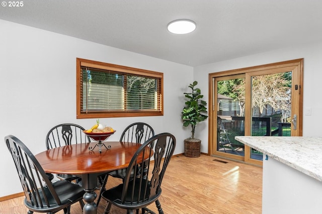 dining room with light hardwood / wood-style floors