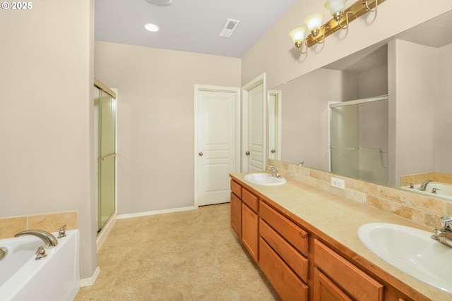 bathroom featuring a stall shower, a sink, and double vanity