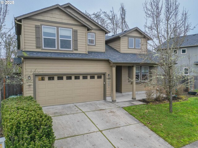 view of front of property featuring a front yard and a garage