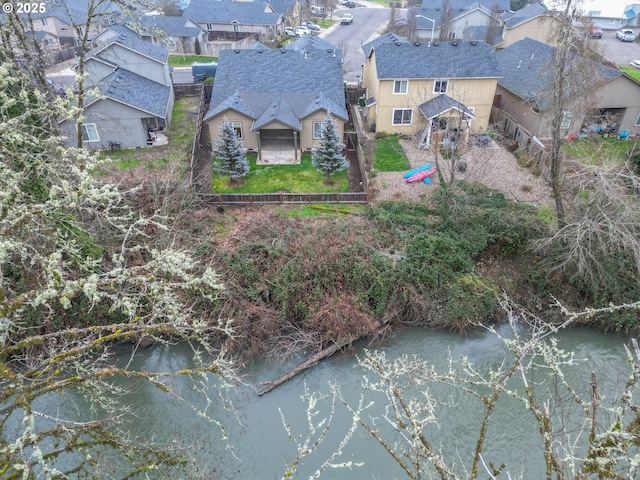 birds eye view of property with a water view and a residential view