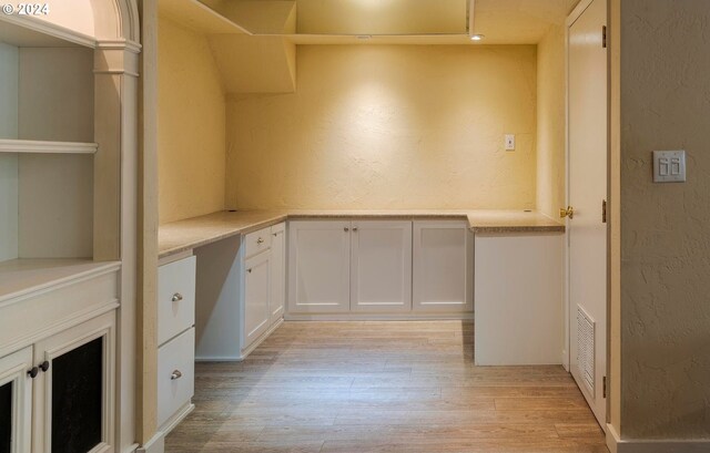 washroom with ornate columns and light hardwood / wood-style floors