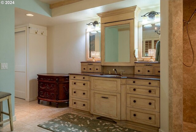 bathroom featuring walk in shower, vanity, and tile patterned floors