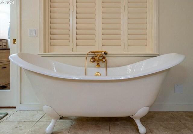 bathroom featuring a washtub and tile patterned floors