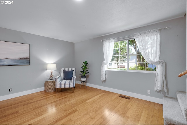 living area with hardwood / wood-style floors