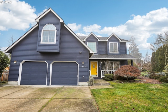 view of front of house featuring a garage, a front yard, and a porch