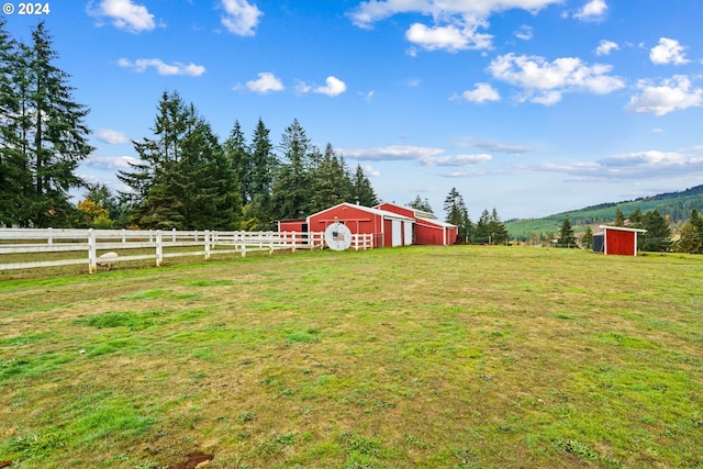 view of yard featuring an outbuilding and a rural view