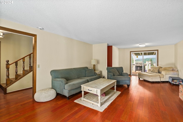 living room featuring hardwood / wood-style floors and a textured ceiling