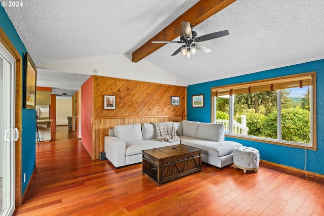 living room with ceiling fan, hardwood / wood-style floors, and a textured ceiling