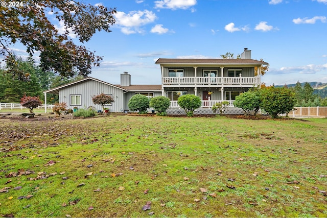 view of front of home with a balcony, a front lawn, and covered porch