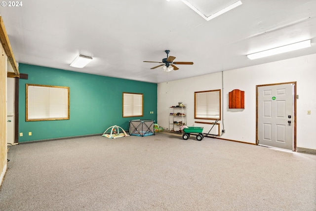 rec room with carpet floors, baseboards, and a ceiling fan