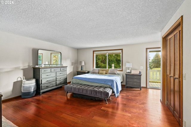 bedroom featuring a closet, a textured ceiling, and hardwood / wood-style flooring