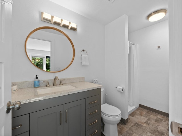 bathroom with walk in shower, vanity, and toilet