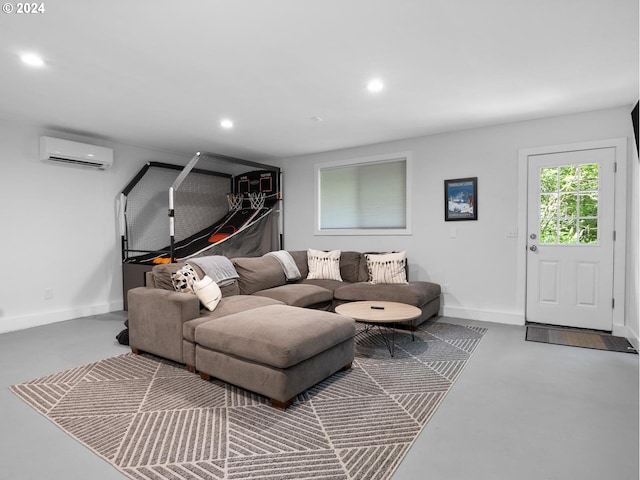 living room featuring a wall unit AC and concrete floors