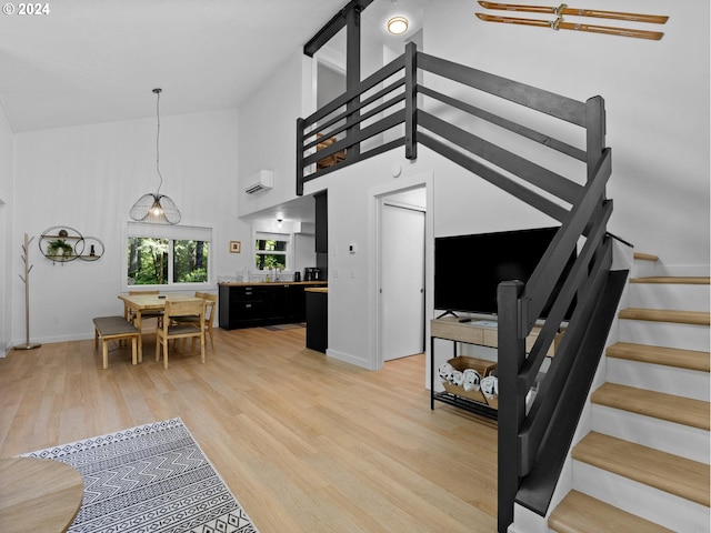 interior space featuring high vaulted ceiling and light hardwood / wood-style floors