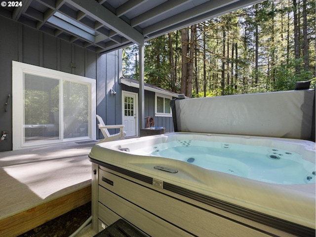 wooden terrace featuring a hot tub