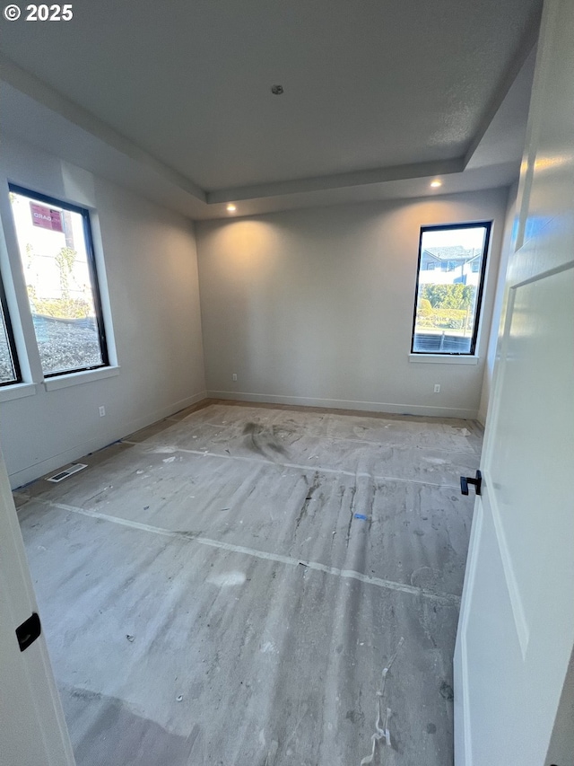 spare room featuring a tray ceiling