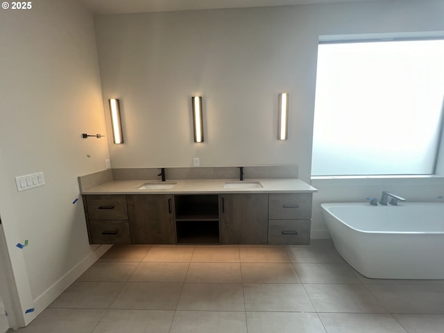 bathroom with vanity, a washtub, and tile patterned flooring