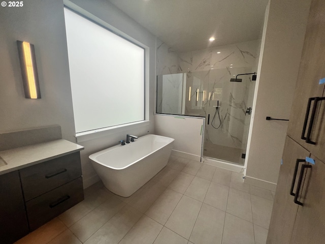 bathroom with vanity and shower with separate bathtub