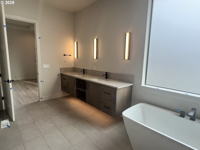 bathroom featuring vanity, tile patterned floors, and a bathing tub