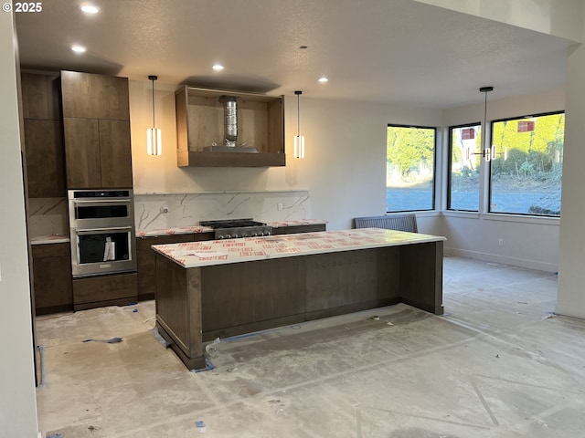 kitchen featuring a kitchen island, appliances with stainless steel finishes, and pendant lighting