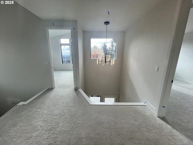 bedroom with light carpet and a raised ceiling