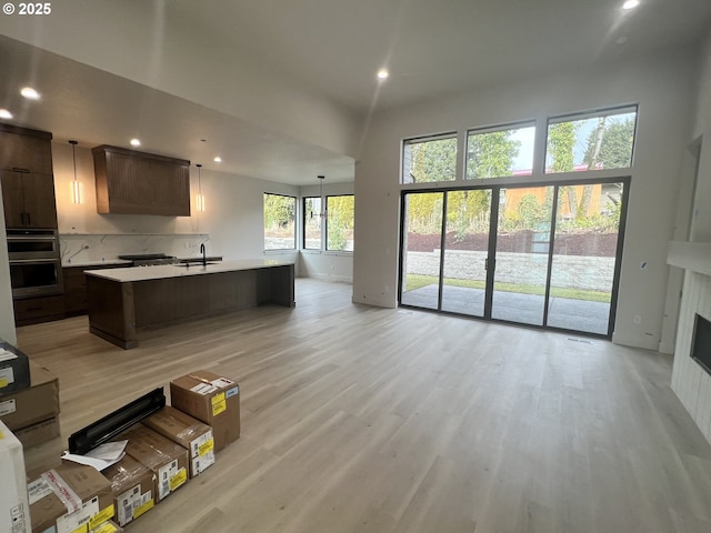 living room with sink and light hardwood / wood-style flooring