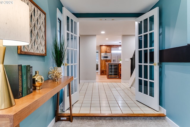 entryway with recessed lighting, baseboards, wine cooler, and light tile patterned flooring