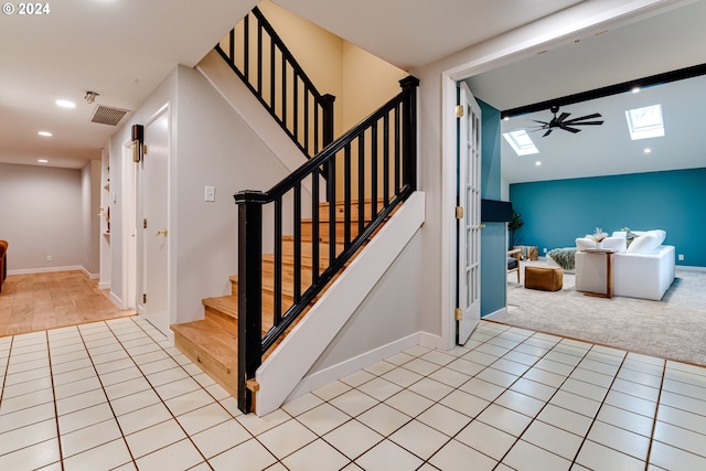 stairway featuring tile patterned flooring, a skylight, recessed lighting, and visible vents