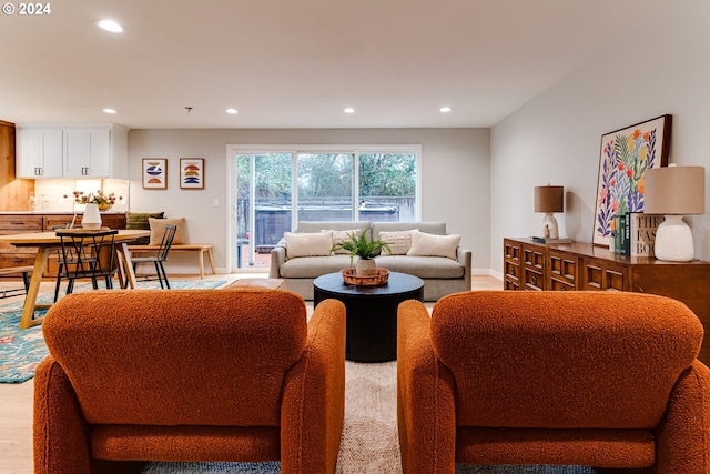 living area with recessed lighting, light wood-type flooring, and baseboards