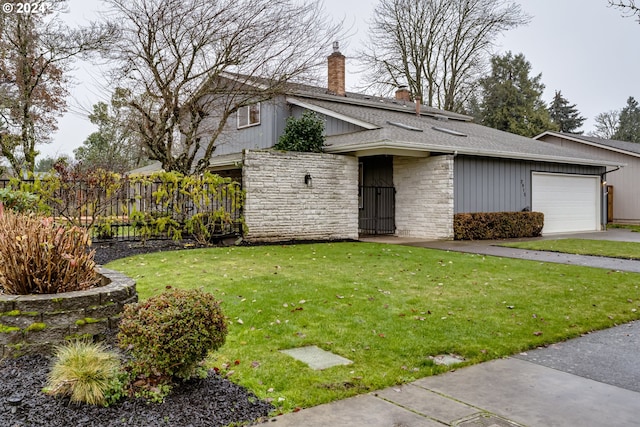 mid-century home with a shingled roof, stone siding, a chimney, an attached garage, and a front yard