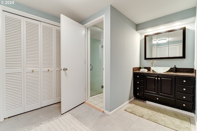 full bath with tile patterned floors, a closet, a stall shower, and vanity