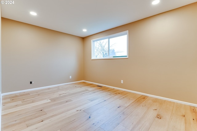 spare room with recessed lighting, baseboards, and light wood finished floors