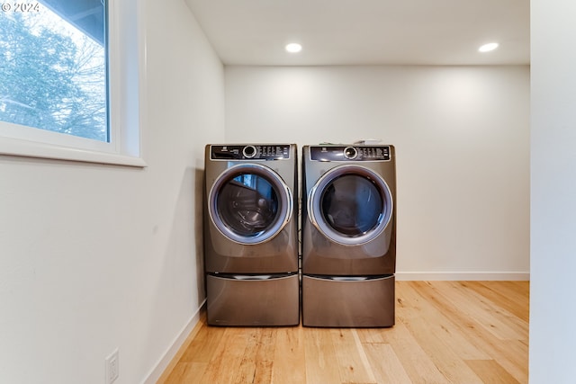 laundry area with washer and clothes dryer, wood finished floors, recessed lighting, baseboards, and laundry area