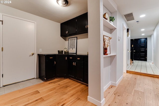 bar with recessed lighting, visible vents, light wood-type flooring, and baseboards