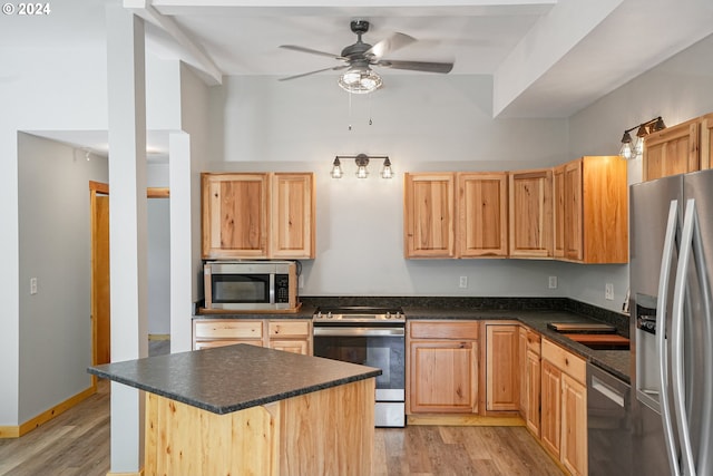 23835 Greasy Creek Rd, Philomath, OR 97370 - kitchen featuring appliances with stainless steel finishes, dark countertops, a ceiling fan, and light wood-type flooring