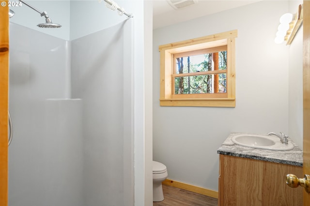 23835 Greasy Creek Rd, Philomath, OR 97370 - full bathroom featuring a shower, toilet, wood finished floors, vanity, and baseboards