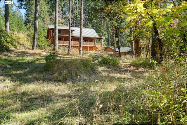 23835 Greasy Creek Rd, Philomath, OR 97370 - back of house featuring a standing seam roof, metal roof, and a view of trees