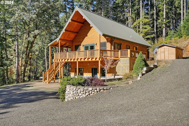 23835 Greasy Creek Rd, Philomath, OR 97370 - log cabin featuring stairs, a wooden deck, metal roof, log exterior, and driveway