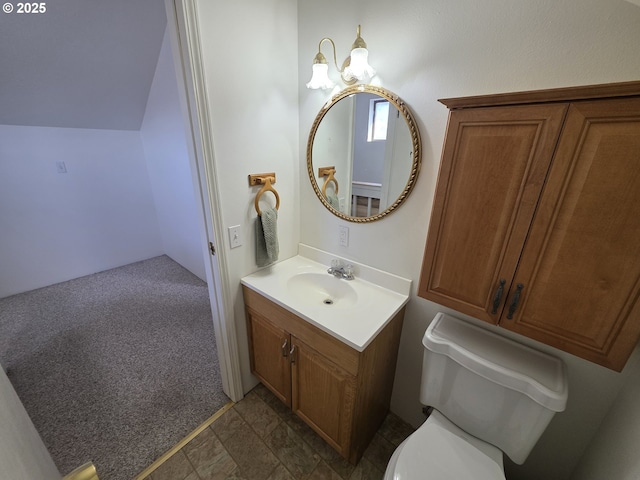 bathroom with a notable chandelier, vaulted ceiling, vanity, and toilet