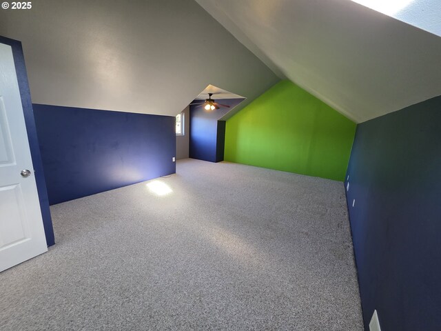 additional living space with carpet flooring and lofted ceiling