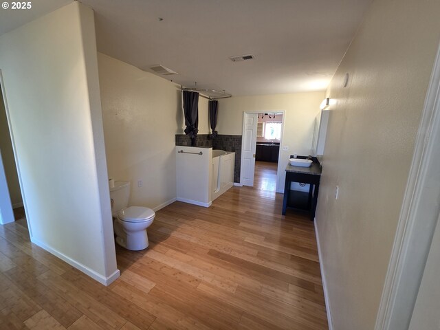 corridor with light hardwood / wood-style flooring