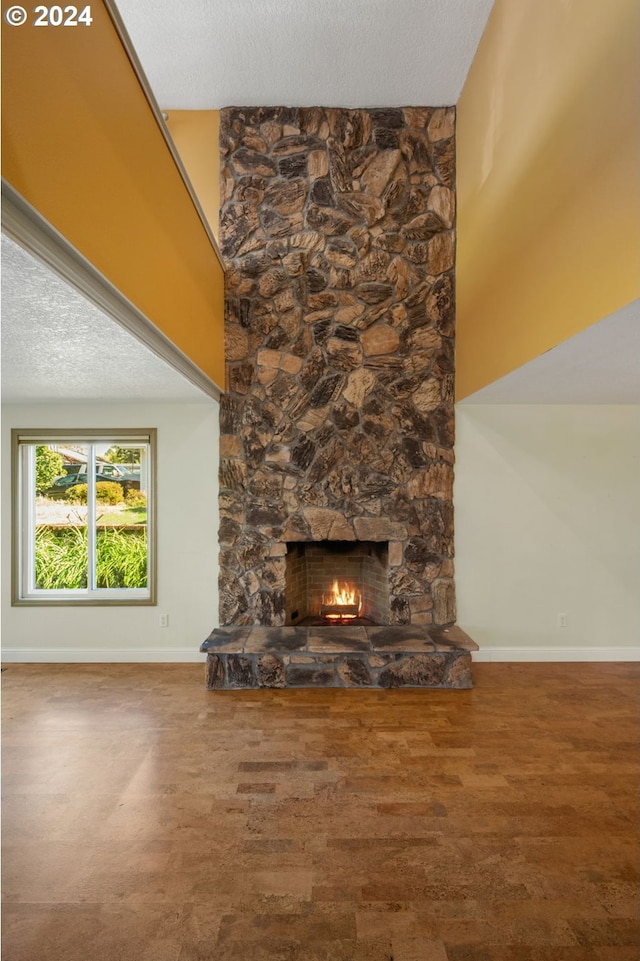 unfurnished living room with a textured ceiling and a fireplace