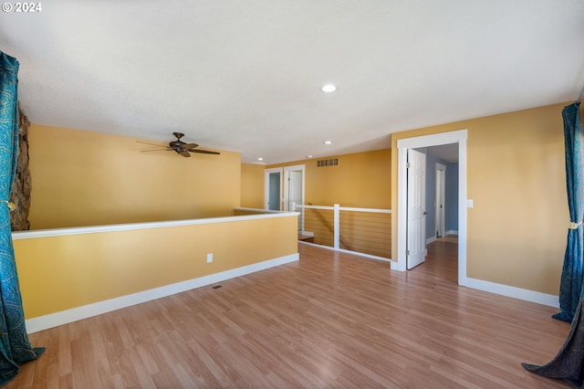 spare room featuring light wood-style flooring, visible vents, baseboards, and recessed lighting