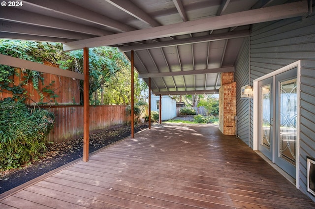 wooden deck featuring fence and an outdoor structure