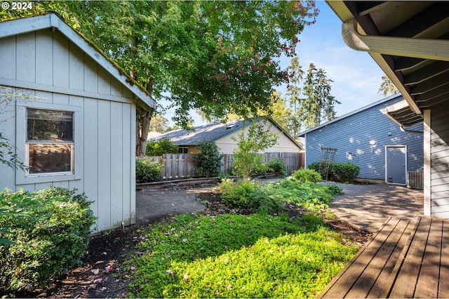 view of yard featuring fence and a wooden deck