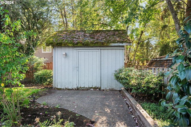 view of shed featuring fence