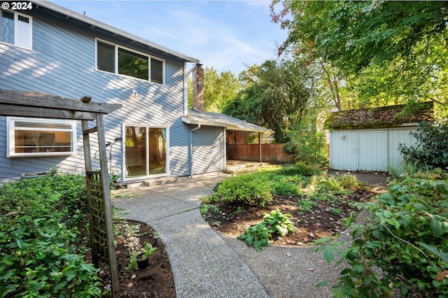 exterior space with a patio, a shed, an outdoor structure, and fence